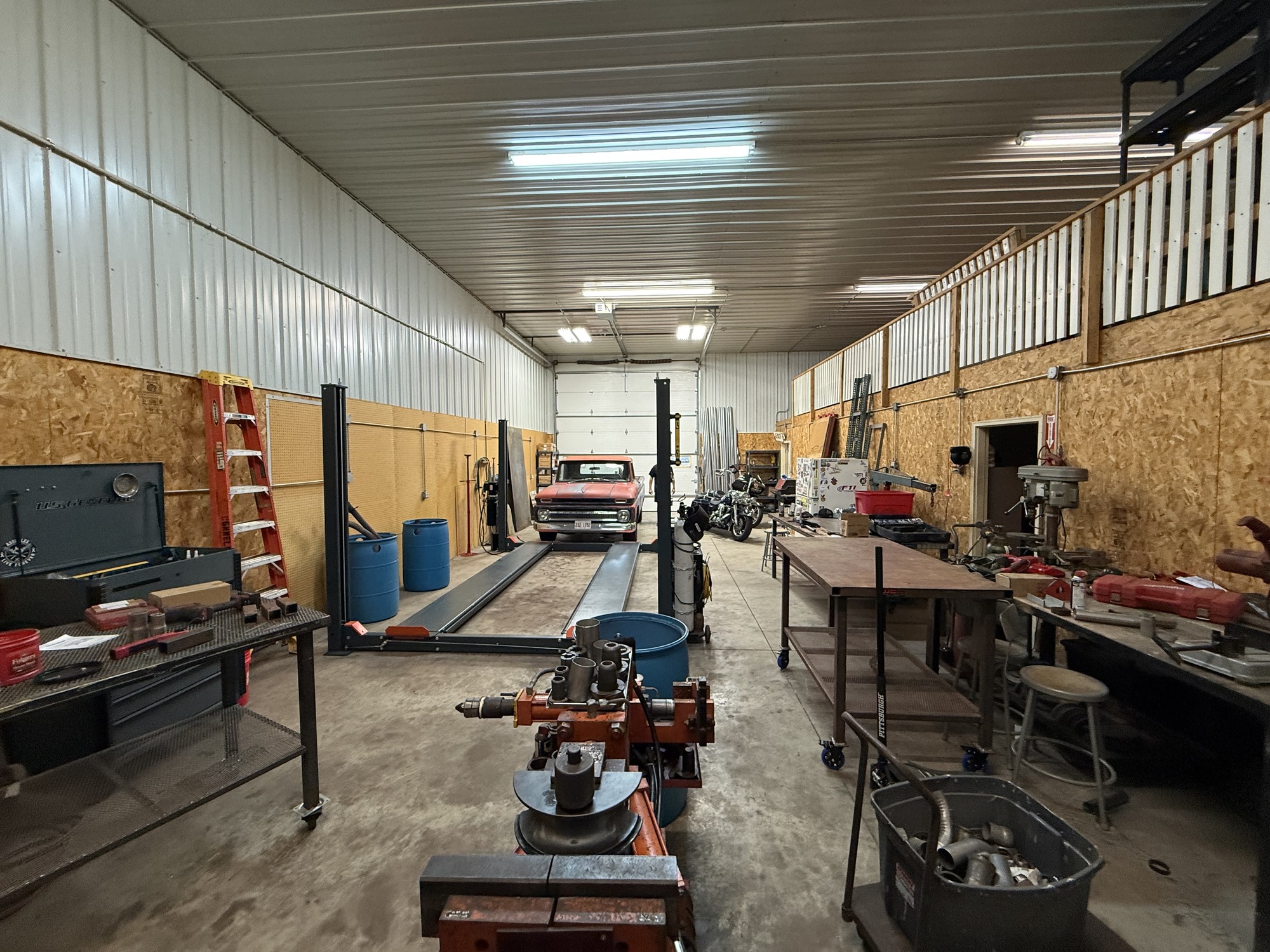 Unit 2 warehouse interior with vehicle lift and mezzanine storage